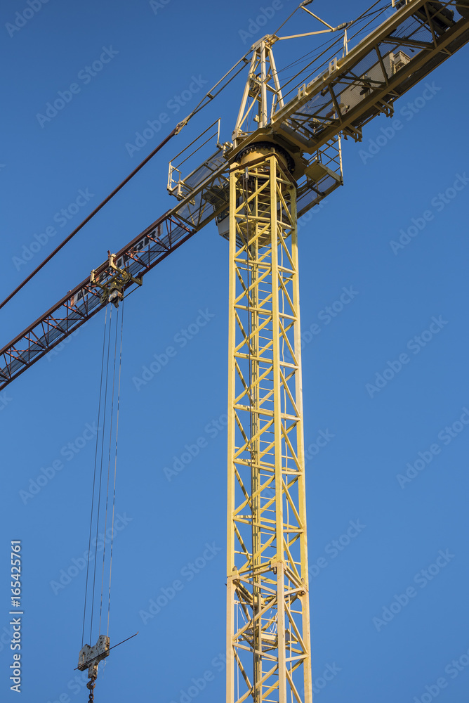 Construction crane on a clear blue sky background Construction crane on a clear blue sky background