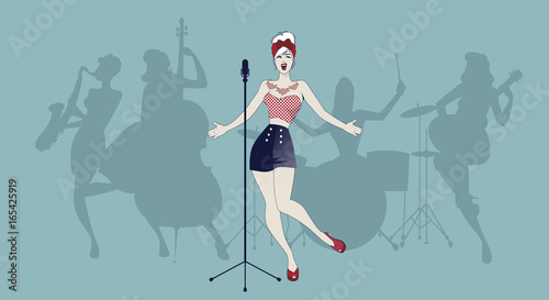 Beautiful and tattooed pin-up girl singing with ladies band in the background