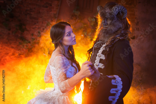 Foto Fine art photo. Beautiful girl and a monster, dance