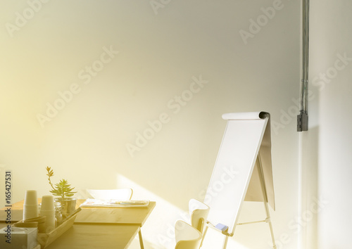 wooden table in meeting room with Flip chart sunlight from window