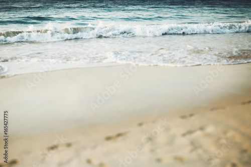 Blue water splashes on the sandy beach © IVASHstudio