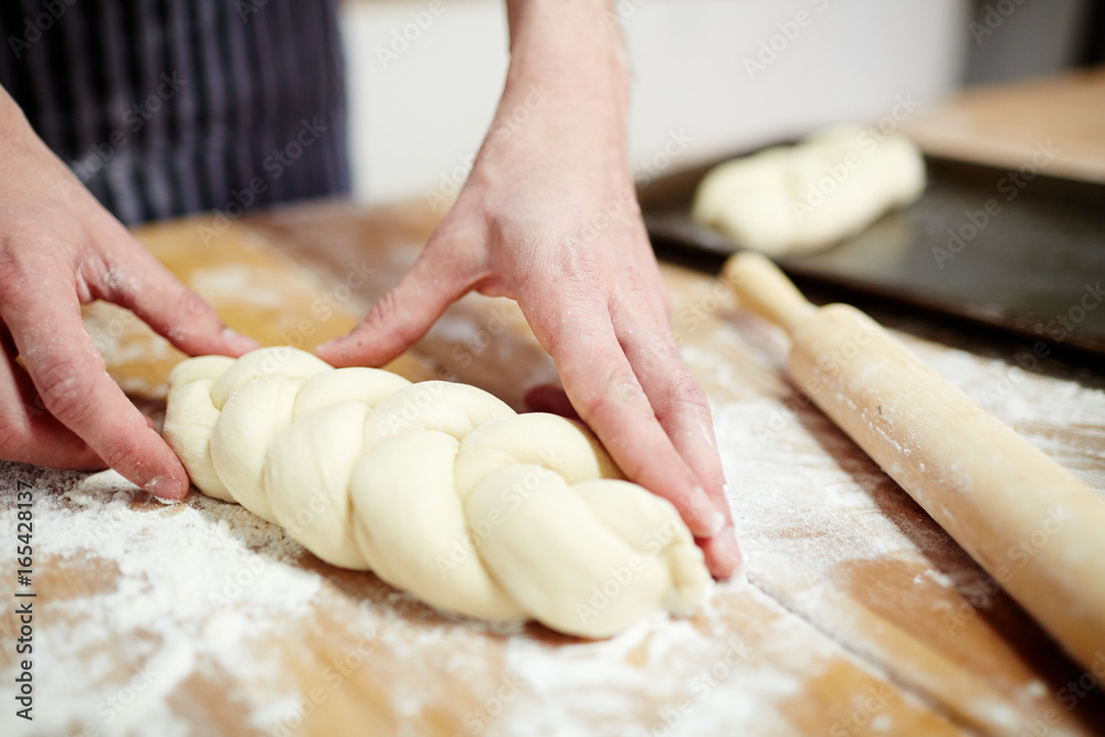 Pastry-chef making bread from dough