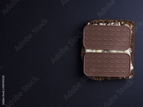 Danish rye bread with butter and pålægschokolade (thin square pieces of chocolate)