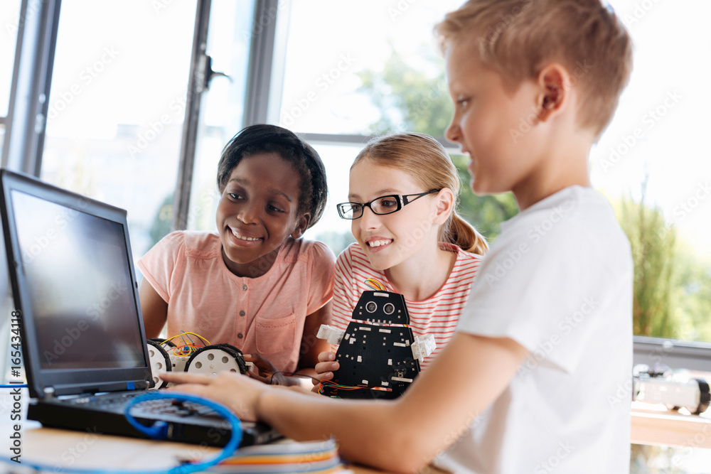 Fair-haired boy showing tutorial video to his friends