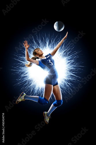 Female professional volleyball player isolated on black © 103tnn