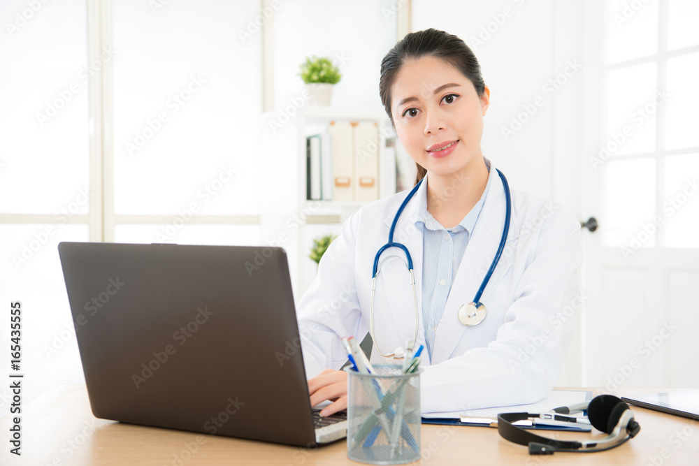 doctor woman typing with laptop system doctor woman typing with laptop system