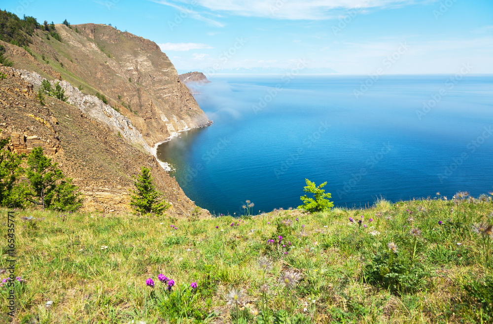 The shore of Lake Baikal is a summer sunny day. View from the island of Olkhon. Summer Landscape