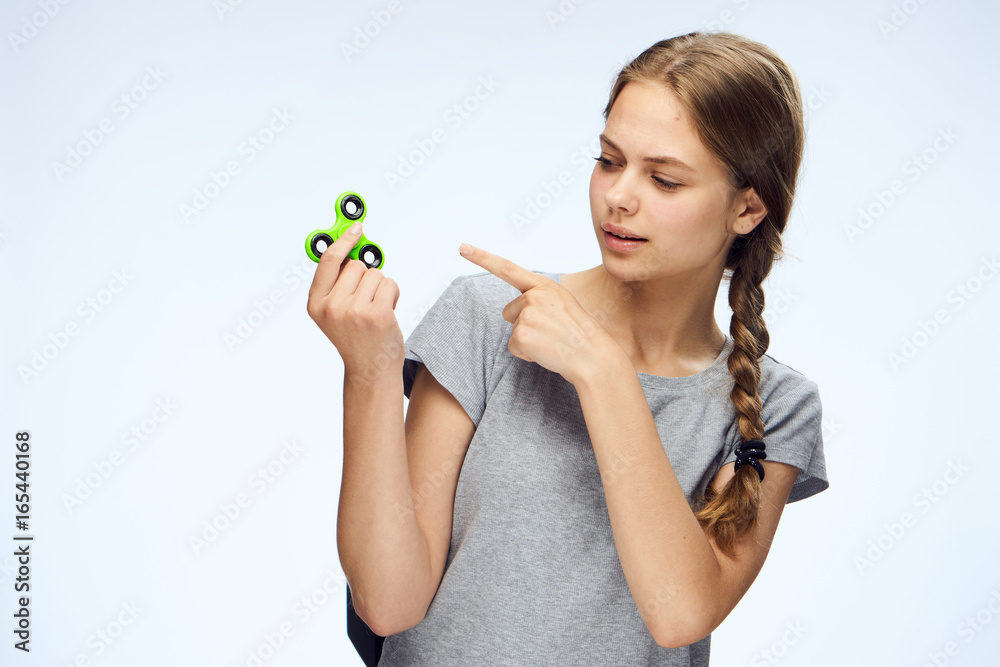 Young beautiful woman on white isolated background holds a spinner Young beautiful woman on white isolated background holds a spinner