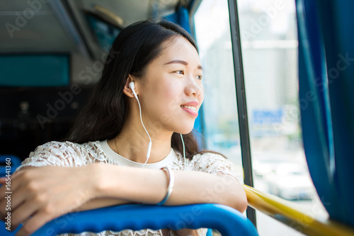 Girl listening to music on a public bus