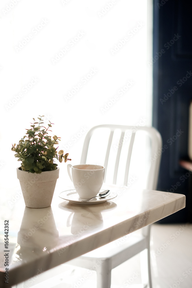 A cup of coffee on table in room,vintage filter,selective focus. A cup of coffee on table in room,vintage filter,selective focus.