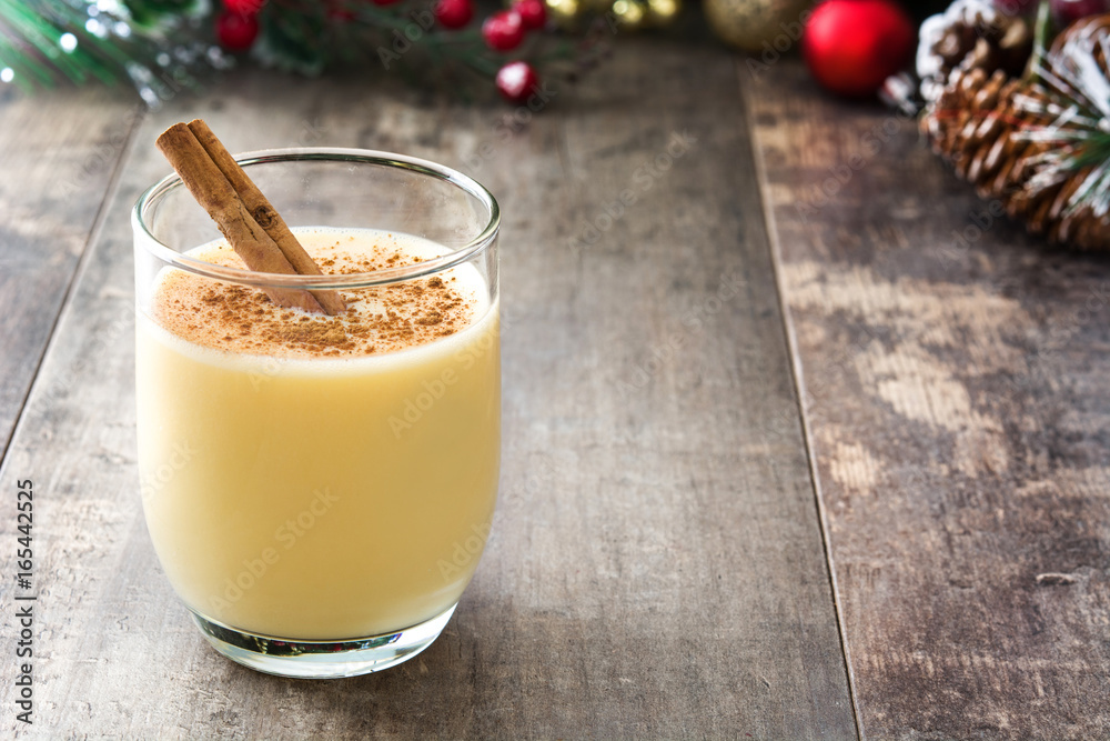 Homemade eggnog with cinnamon on wooden table. Typical Christmas dessert.
Homemade eggnog with cinnamon on wooden table. Typical Christmas dessert.