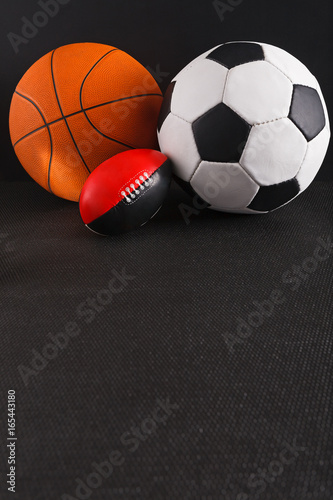 Assorted sport balls on black background
