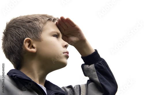The boy with a proud face looks into the distance