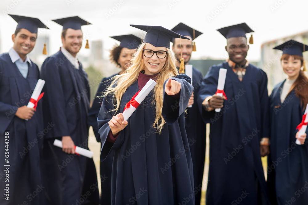 happy student with diploma pointing finger at you happy student with diploma pointing finger at you
