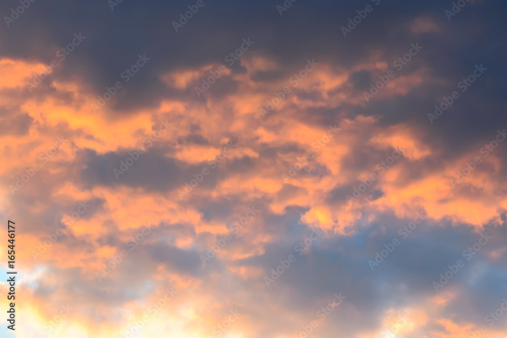 Photo of big fluffy orange clouds after sunset