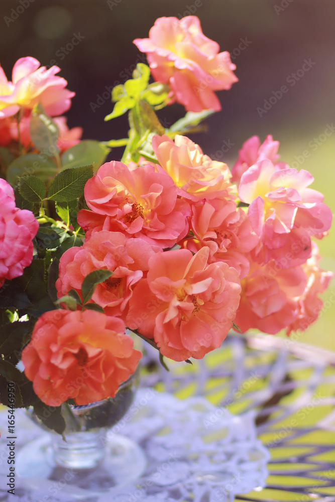 Bouquet of orange roses in a vase in the garden. Orange creeping Rose. Orange Dawn creeping Rose. Bouquet of orange roses in a vase in the garden. Orange creeping Rose. Orange Dawn creeping Rose.