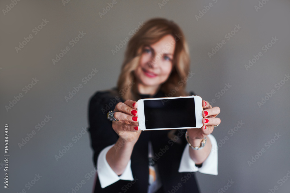 Woman shows her mobile phone screen