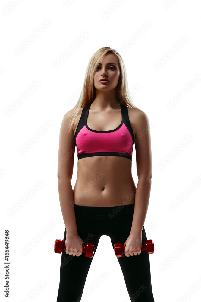 Portrait of a beautiful young blond fitness woman in sportswear lifting dumbbells isolated on white background Portrait of a beautiful young blond fitness woman in sportswear lifting dumbbells isolated on white background
