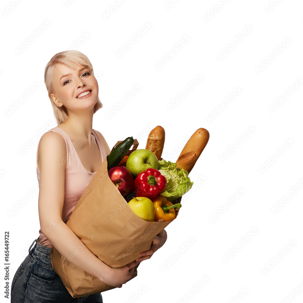Portrait of happy smiling woman with groceries shopping bag full of vegetables isolated on white background Portrait of happy smiling woman with groceries shopping bag full of vegetables isolated on white background