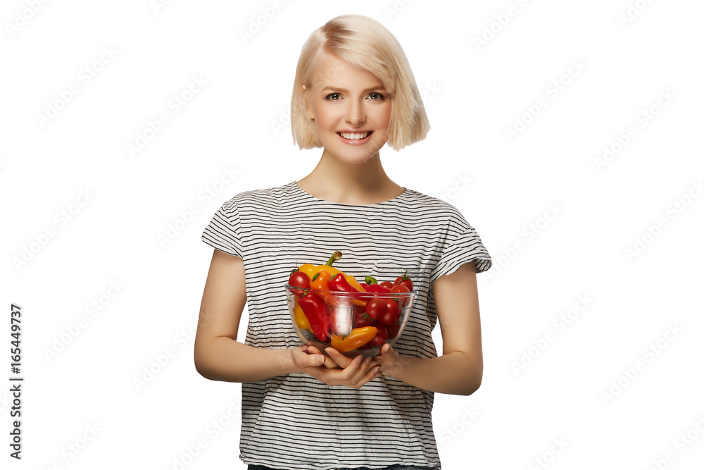 Young woman holding bowl of vegetables pepper and tomatoes isolated on white background Young woman holding bowl of vegetables pepper and tomatoes isolated on white background