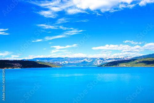 A large mountain lake and mountains.