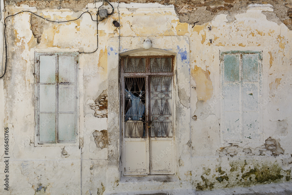 Facade of an abandoned building in Paleo Karlovasi village on Samos island, Greece. 
