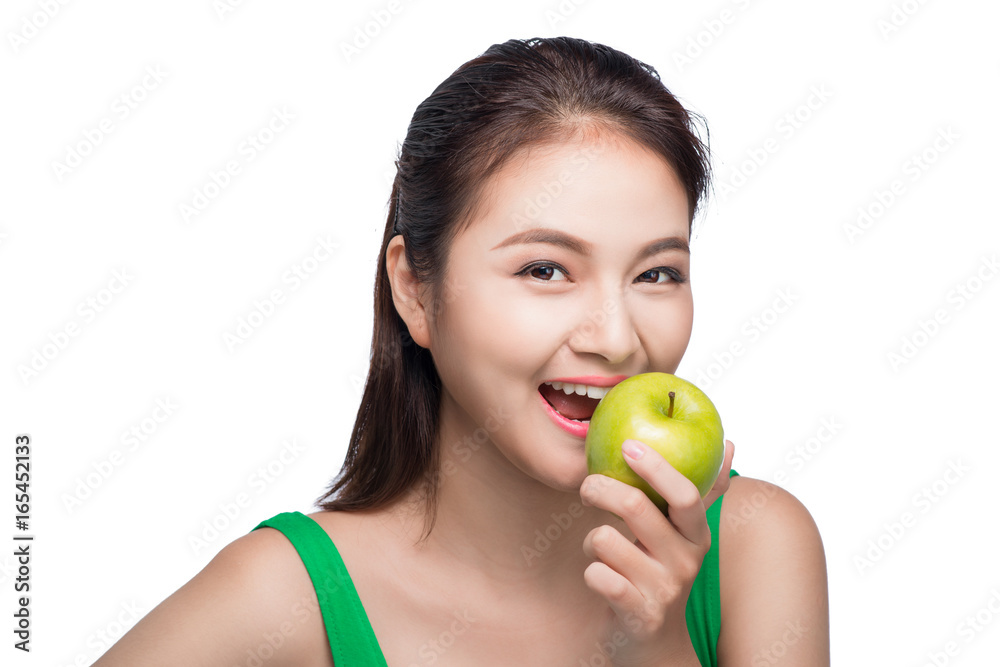 Young beautiful asian woman eating fresh green apple on white background Young beautiful asian woman eating fresh green apple on white background