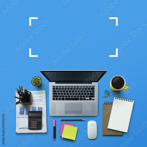 Office workplace with laptop, notebook, office supplies and stationery on blue background. Solution, business planning, data analysis, creative, design, start, or working flat lay top view concept.