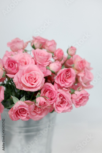Pink bush roses in a bucket