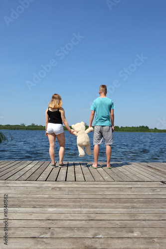 Two teenagers on a lake date.