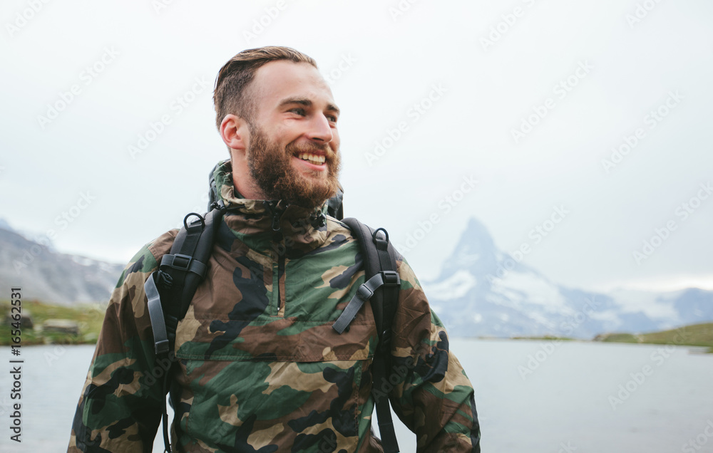 Man hiking to Matterhorn Mountain in summer in Zermatt city, Switzerland Man hiking to Matterhorn Mountain in summer in Zermatt city, Switzerland