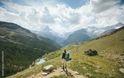 Man hiking to Matterhorn Mountain in summer in Zermatt city, Switzerland