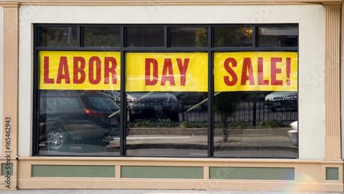 LABOR DAY SALE banner stretched across store window.