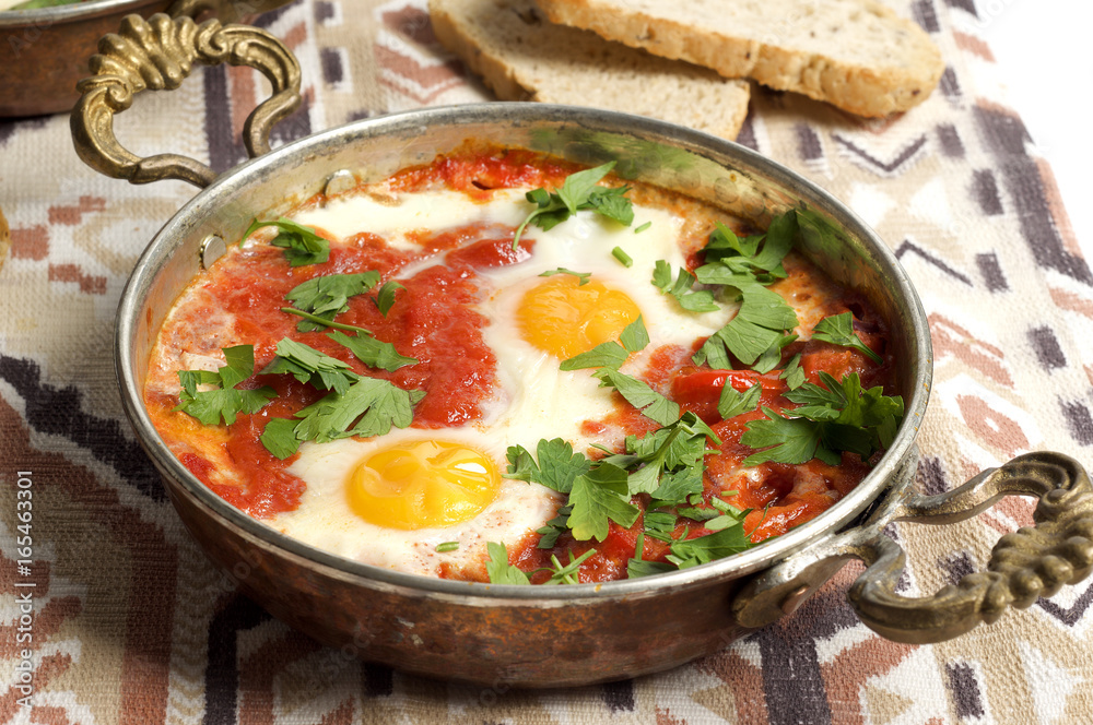 Tomato and red pepper shakshouka with hummus and wholemeal bread
