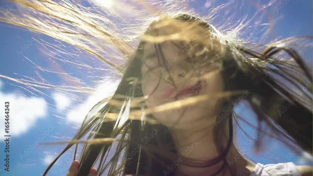 Hair of pretty little girl hair is blowing in the wind