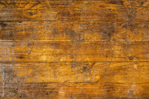 Background and texture of weathered ywllow wooden planks photo