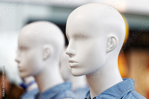 Closeup plastic mannequin heads against blurred background. Shallow focus. photo