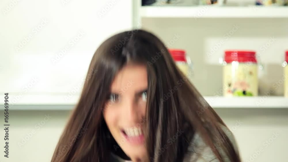 Gorgeous woman dancing in kitchen looking camera happy Gorgeous woman dancing in kitchen looking camera happy