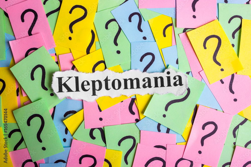 Kleptomania Syndrome text on colorful sticky notes Against the background of question marks