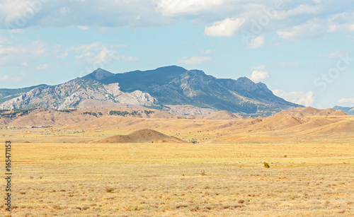 Panorama of the semi-desert with withered grass, hills and mountains in the background. Peninsula of Crimea