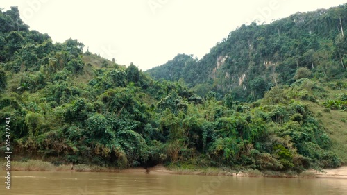 Traveling by boat down the river Nam Ou, Laos. Beautiful views from the boat. photo