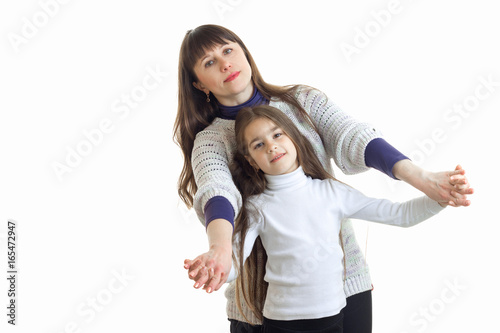 young mother stands in the Studio with daughter and holding her hands