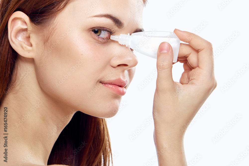 A young beautiful woman on a white isolated background burying her eyes A young beautiful woman on a white isolated background burying her eyes