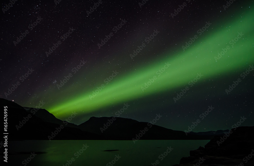 Northern lights at night over a lake in Igaliko