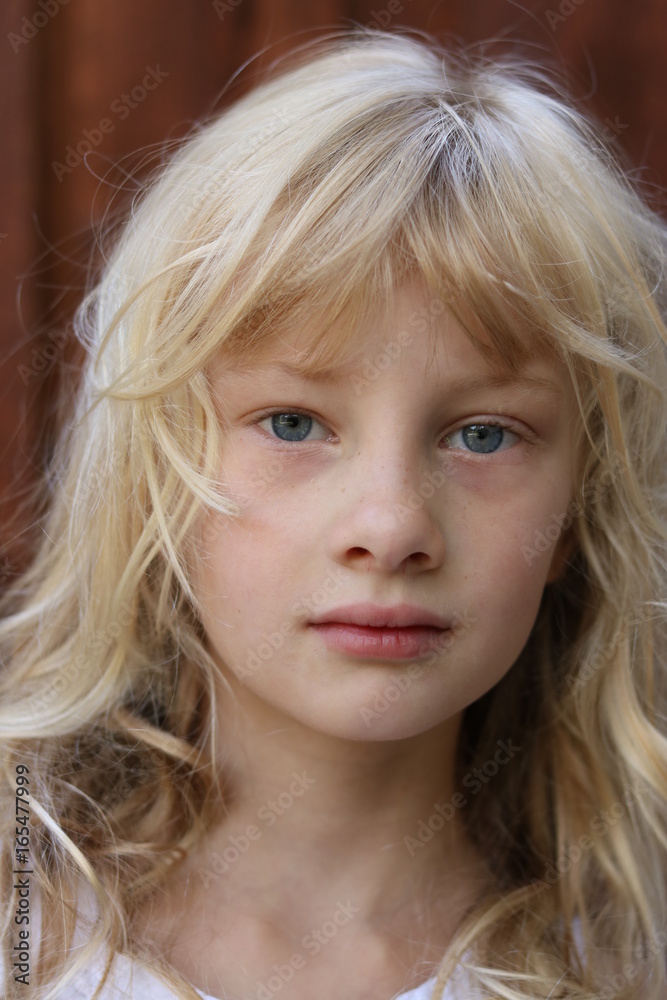Close up portrait of a young blonde blue eyed girl Close up portrait of a young blonde blue eyed girl