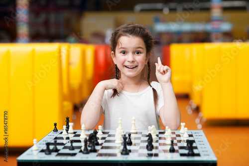 Little girl playing chess photo