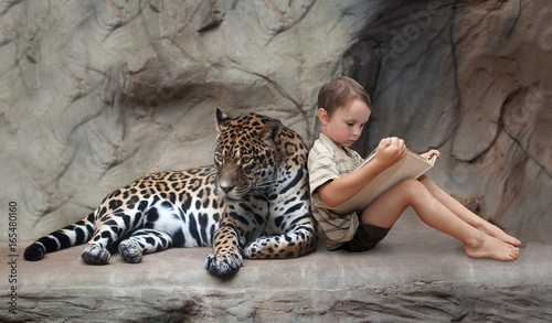 Fototapeta Naklejka Na Ścianę i Meble -  child reading a book and panther