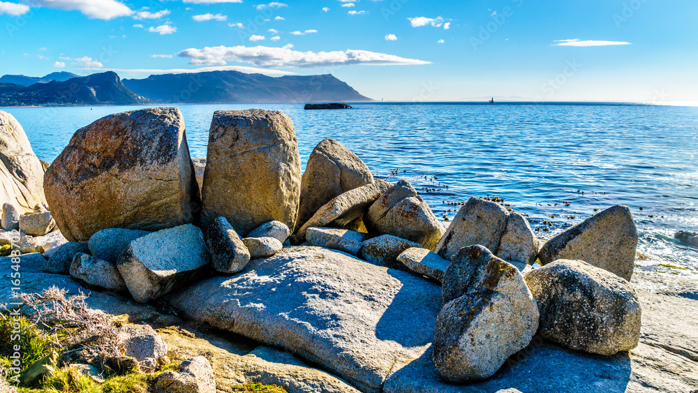 Fototapeta premium Large granite boulders at Boulders Beach, a popular nature reserve and home to a colony of African Penguins, in the village of Simons Town in the Cape Peninsula of South Africa