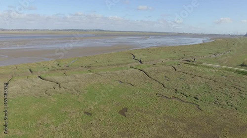 Aerial footage flying close to Flint Castle turret with view of Dee Estuary.