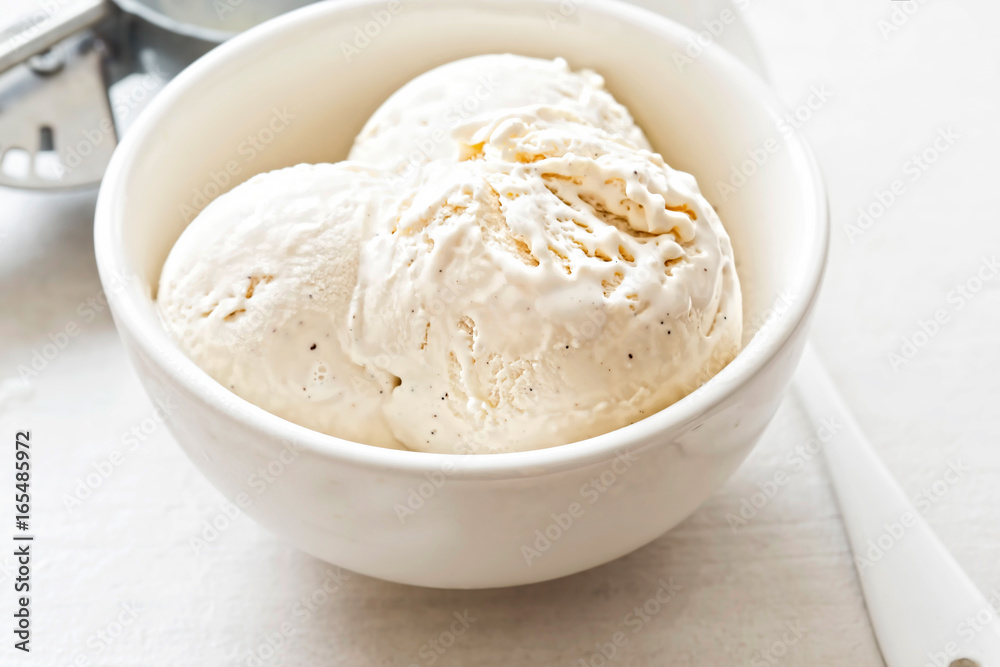 Vanilla ice cream scoops in white bowl 